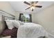 Bedroom featuring a bed with decorative pillows, a ceiling fan, and a large window at 2904 Britmass Dr, Raleigh, NC 27616
