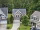 Two-story home with a two-car garage and a curved driveway, surrounded by landscaped lawn and trees at 2904 Britmass Dr, Raleigh, NC 27616