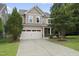 Charming two-story home featuring a two-car garage and well-manicured front yard at 2904 Britmass Dr, Raleigh, NC 27616