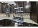 Close up of kitchen featuring stainless steel appliances, granite counters, and dark cabinetry at 2904 Britmass Dr, Raleigh, NC 27616
