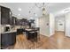 Modern kitchen with stainless steel appliances, dark cabinetry, and granite countertops at 2904 Britmass Dr, Raleigh, NC 27616