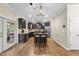 Modern kitchen with a kitchen island, dark cabinets, stainless steel appliances, and hardwood floors at 2904 Britmass Dr, Raleigh, NC 27616