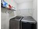 Laundry room featuring newer front-load washer and dryer with wire shelving for storage at 2904 Britmass Dr, Raleigh, NC 27616