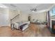 Spacious living room with hardwood floors, fireplace, ceiling fan, and staircase at 2904 Britmass Dr, Raleigh, NC 27616