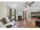 Comfortable living room with fireplace, hardwood floors, and a view into the kitchen area at 2904 Britmass Dr, Raleigh, NC 27616