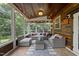 Cozy sunroom with wood paneling, many windows and comfortable seating at 2904 Britmass Dr, Raleigh, NC 27616