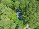 Aerial view showcases the home nestled among lush, mature trees, providing shade and privacy at 3006 Pump Station Ln, Durham, NC 27712