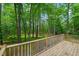 A wooden back deck overlooks a peaceful wooded area at 3006 Pump Station Ln, Durham, NC 27712