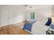 Cozy bedroom with hardwood floors, ceiling fan, and large windows offering ample natural light at 3006 Pump Station Ln, Durham, NC 27712