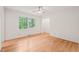 Inviting bedroom featuring hardwood floors and large windows providing ample natural light at 3006 Pump Station Ln, Durham, NC 27712