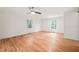 Bright bedroom with hardwood floors, a ceiling fan, and large windows for natural light at 3006 Pump Station Ln, Durham, NC 27712