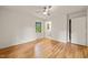 Sun-filled bedroom features hardwood floors, ceiling fan, and two windows at 3006 Pump Station Ln, Durham, NC 27712