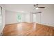 Spacious bedroom featuring hardwood floors, ample natural light, and a ceiling fan at 3006 Pump Station Ln, Durham, NC 27712