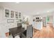 Cozy dining area with built-in cabinets, and an open view to the modern kitchen at 3006 Pump Station Ln, Durham, NC 27712