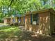 Exterior view of the home surrounded by green trees at 3006 Pump Station Ln, Durham, NC 27712