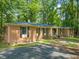 Charming brick home featuring a well-manicured lawn, dark shutters, and a welcoming front entrance at 3006 Pump Station Ln, Durham, NC 27712
