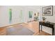 Bright foyer featuring hardwood floors, a colorful accent rug, and an inviting view into other rooms at 3006 Pump Station Ln, Durham, NC 27712
