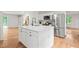 Well-equipped kitchen with a large island, stainless steel refrigerator, and sleek countertops at 3006 Pump Station Ln, Durham, NC 27712