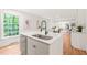 Bright kitchen featuring a stainless steel dishwasher, modern faucet, and ample counter space at 3006 Pump Station Ln, Durham, NC 27712