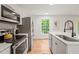 Efficient kitchen with stainless steel appliances, hardwood floors, and a sunlit window at 3006 Pump Station Ln, Durham, NC 27712