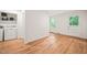 Bright laundry room with hardwood floors, washer, dryer, and convenient built-in shelving at 3006 Pump Station Ln, Durham, NC 27712