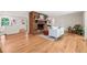 Bright living room featuring a brick fireplace, hardwood floors, and abundant natural light at 3006 Pump Station Ln, Durham, NC 27712
