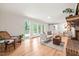 Bright living room with hardwood floors, patio access, brick fireplace, and cozy seating at 3006 Pump Station Ln, Durham, NC 27712