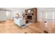 Cozy living room featuring hardwood floors, brick fireplace, and views to the kitchen and entry at 3006 Pump Station Ln, Durham, NC 27712