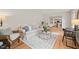 Cozy living room featuring hardwood floors, neutral decor, and comfortable seating with views to the kitchen at 3006 Pump Station Ln, Durham, NC 27712