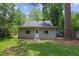 The home's backyard features a grassy lawn and lots of mature trees at 308 Greenwood Dr, Durham, NC 27704