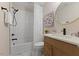 Modern bathroom with vanity, marble floors, and decorative shower curtain at 308 Greenwood Dr, Durham, NC 27704