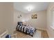 Bright bedroom with hardwood floors, a single bed, and colorful wall art at 308 Greenwood Dr, Durham, NC 27704