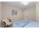 Cozy bedroom featuring light walls, hardwood floors, and a comfy chair with throw at 308 Greenwood Dr, Durham, NC 27704