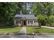 Charming house with manicured lawn, grey siding and black shutters at 308 Greenwood Dr, Durham, NC 27704
