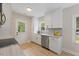 Modern kitchen with stainless steel appliances, granite countertops, and natural light from the windows at 308 Greenwood Dr, Durham, NC 27704