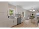 Well-lit kitchen with stainless steel appliances, granite countertops, and adjacent dining area at 308 Greenwood Dr, Durham, NC 27704