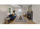 Cozy living room featuring a fireplace, wood floors, ceiling fan and natural light at 308 Greenwood Dr, Durham, NC 27704