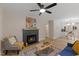 Inviting living room with fireplace, ceiling fan, and open to kitchen at 308 Greenwood Dr, Durham, NC 27704