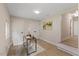 A well-lit office featuring hardwood floors, a white chair, and a view of an open hallway at 308 Greenwood Dr, Durham, NC 27704