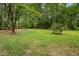 Spacious backyard with mature trees, providing a serene and private outdoor setting at 313 Teresa Dr, Rolesville, NC 27571