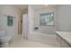 Clean bathroom with a soaking tub, separate shower, and window for natural light at 313 Teresa Dr, Rolesville, NC 27571