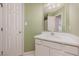 A bright bathroom with a white vanity, sink, and a neutral colored wall at 313 Teresa Dr, Rolesville, NC 27571