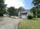 View of home showing a detached garage, long drive, white picket fence and colorful flower boxes at 313 Teresa Dr, Rolesville, NC 27571