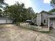 Backyard view of the home showing a detached garage, wooden deck, and white picket fence at 313 Teresa Dr, Rolesville, NC 27571