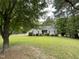 Charming one-story home with lush green lawn and mature trees offering shade and curb appeal at 313 Teresa Dr, Rolesville, NC 27571