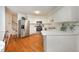 Well-lit kitchen with stainless steel appliances and wooden floors at 313 Teresa Dr, Rolesville, NC 27571