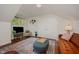 Cozy living room featuring a leather couch, bright natural light, and a neutral rug at 313 Teresa Dr, Rolesville, NC 27571