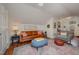 Cozy living room featuring a leather couch, bright natural light, and a neutral rug at 313 Teresa Dr, Rolesville, NC 27571