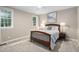 Cozy bedroom with a wood-framed bed, plush carpet, and natural light from two windows at 317 Chanticlair Dr, Apex, NC 27502