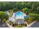 Aerial view of the community pool with several swimming lanes, seating, and a clubhouse at 317 Chanticlair Dr, Apex, NC 27502